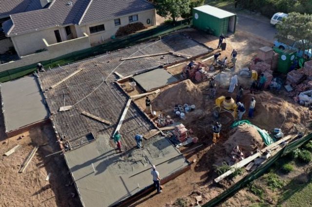 Wire mesh in place and the systematic manual pouring of the slab