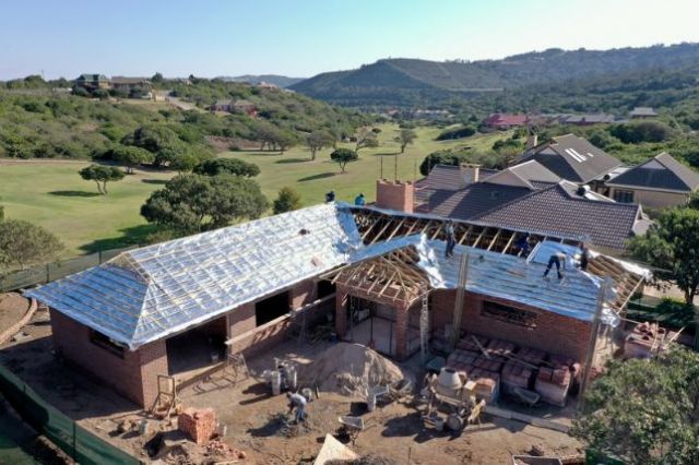 With the roof structure completed, the roof insulation nears finalization prior to the tiling 